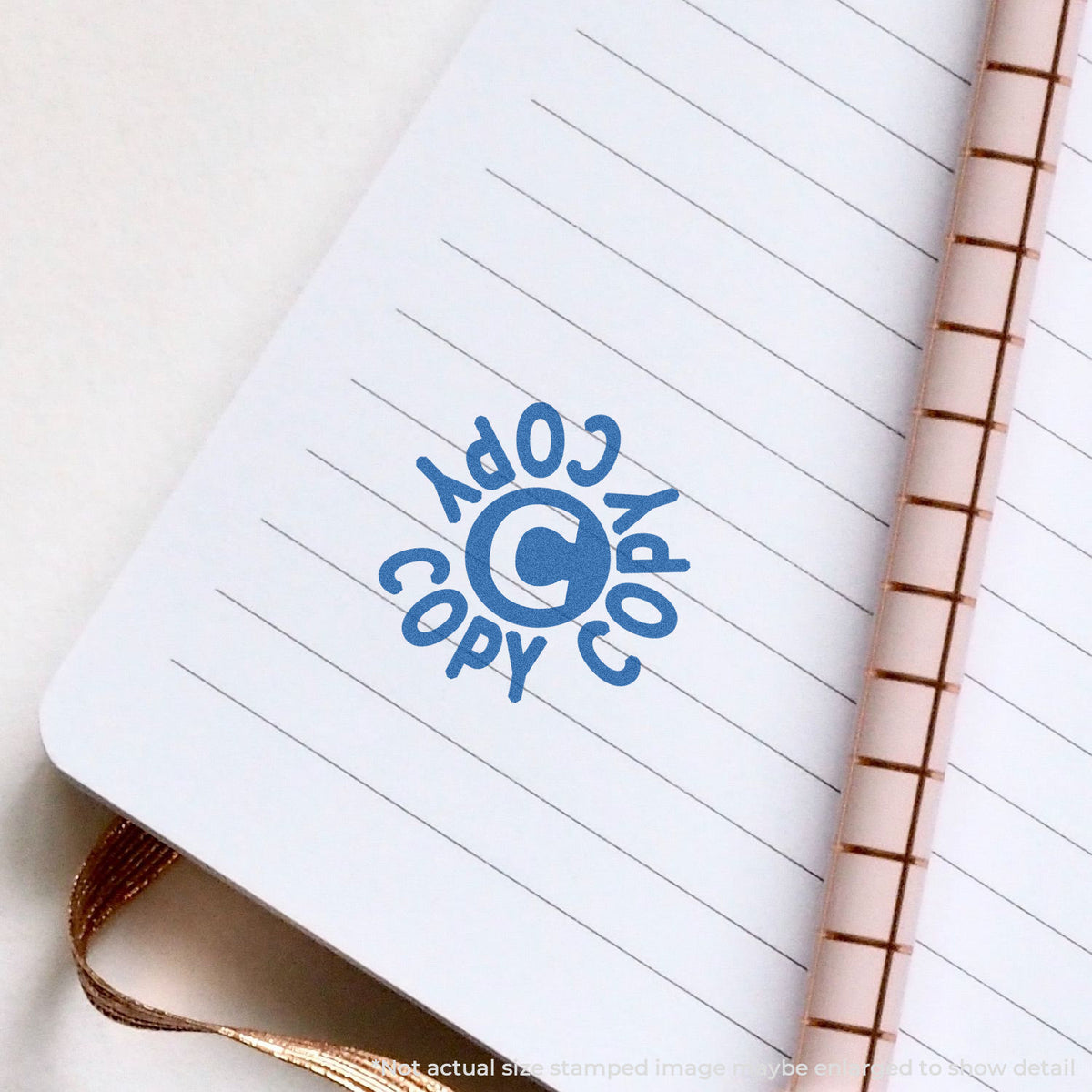 "Copy" pre-inked imprint on a page, round shape at 5/8 in diameter