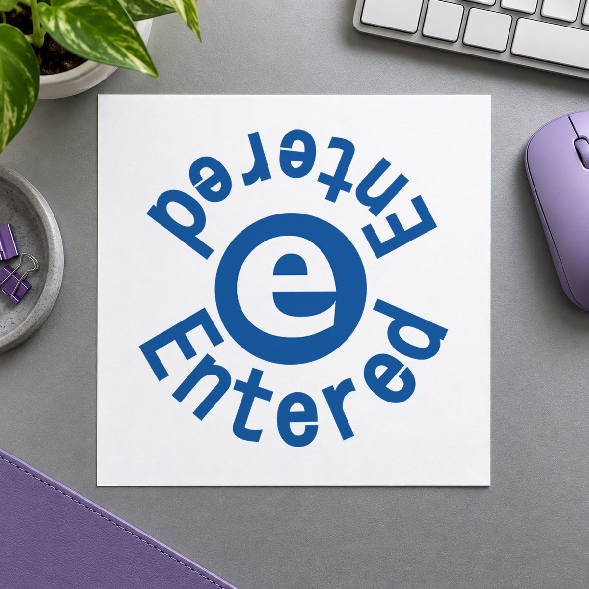 "Entered" Xstamper No. 11423 stamp shown in everyday handling