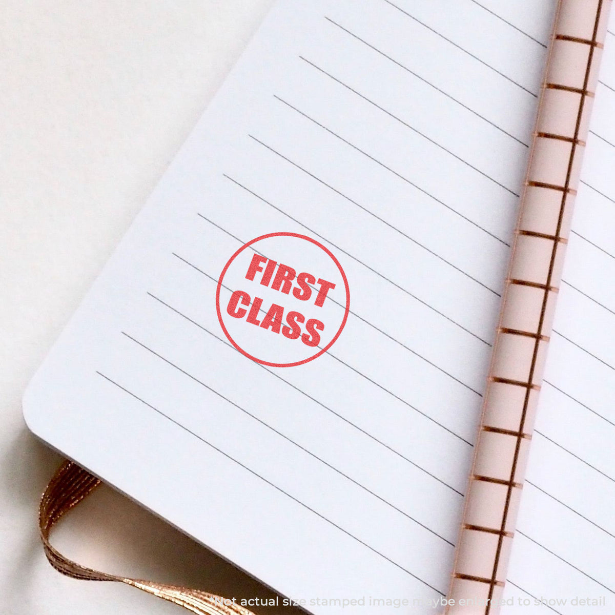 "First class" pre-inked imprint on a page, round shape at Approximately 5/8 in diameter