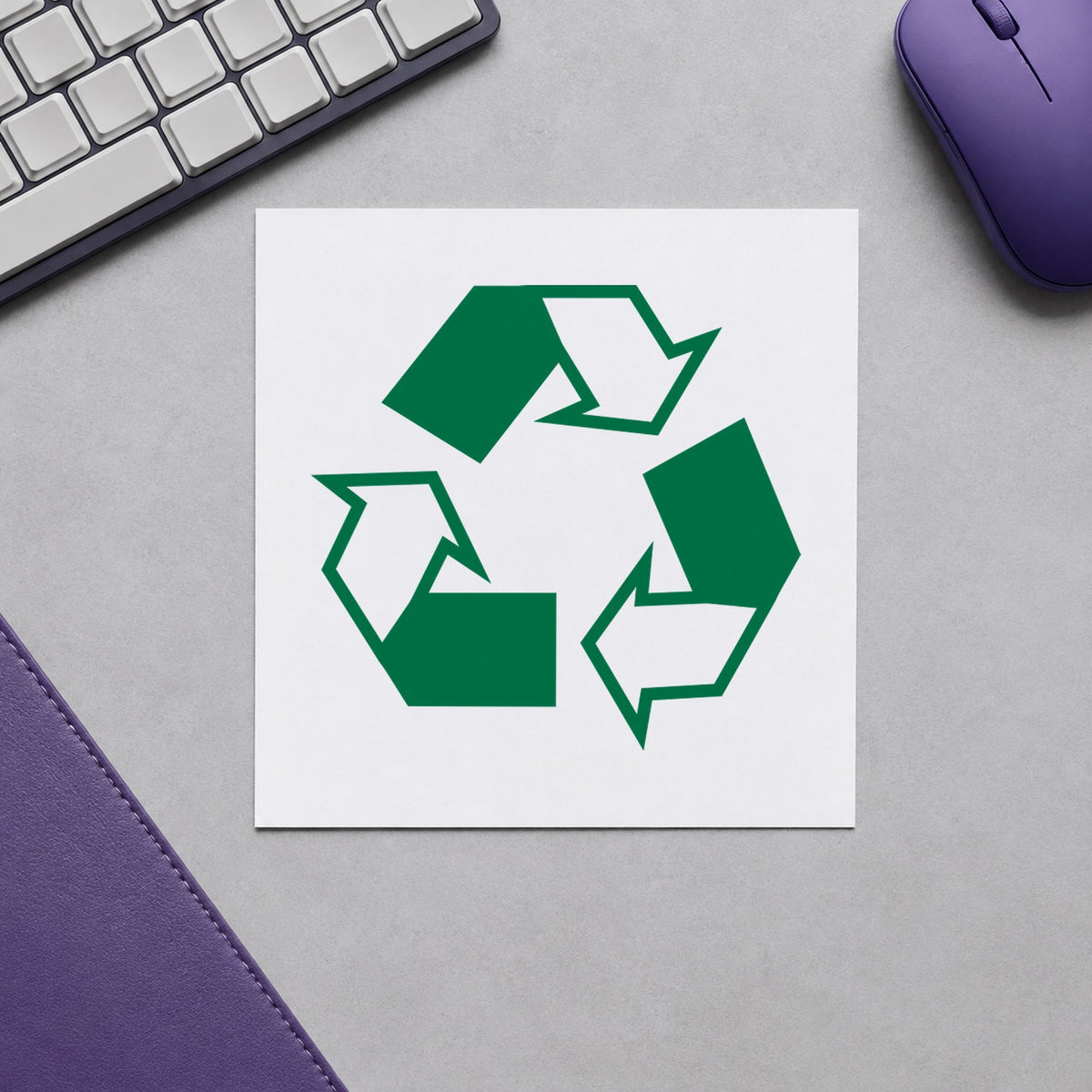 Pre-inked "Recycle logo" stamp marking paperwork in an office setting