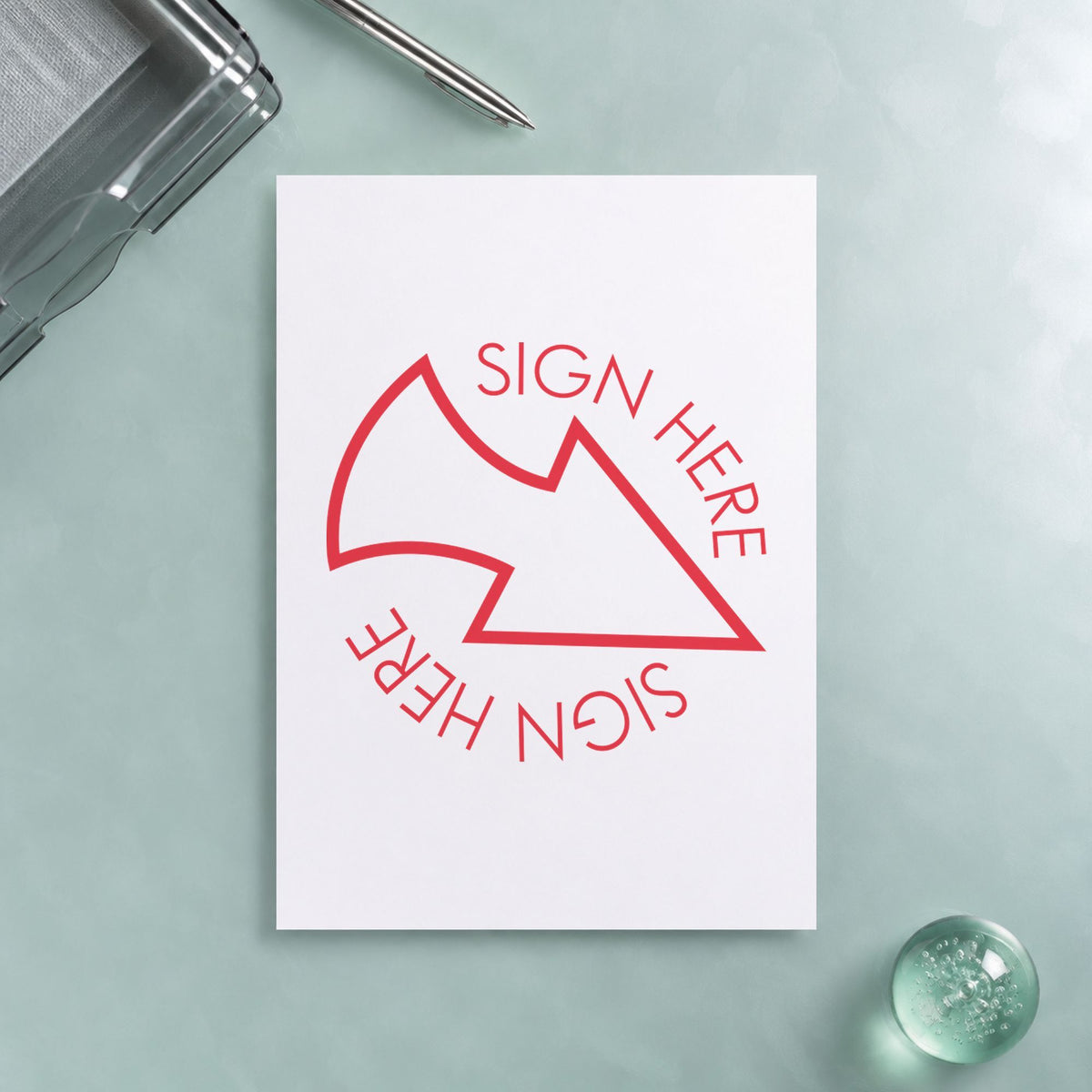 "Sign here" Xstamper pre-inked stamp beside its round imprint