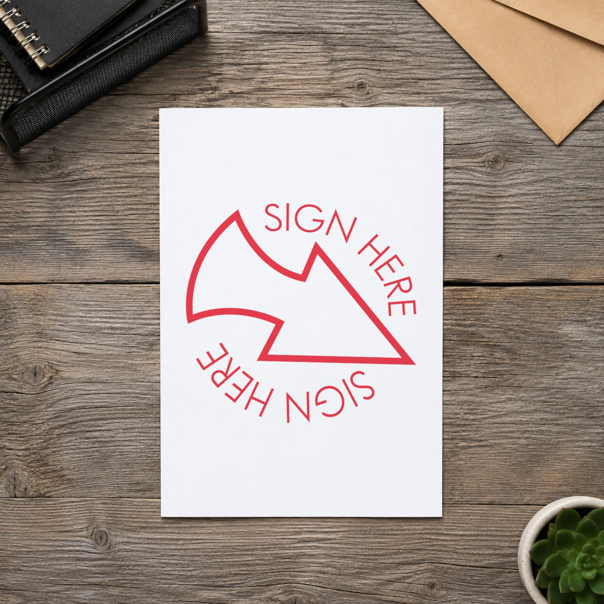 Pre-inked "Sign here" stamp marking paperwork in an office setting