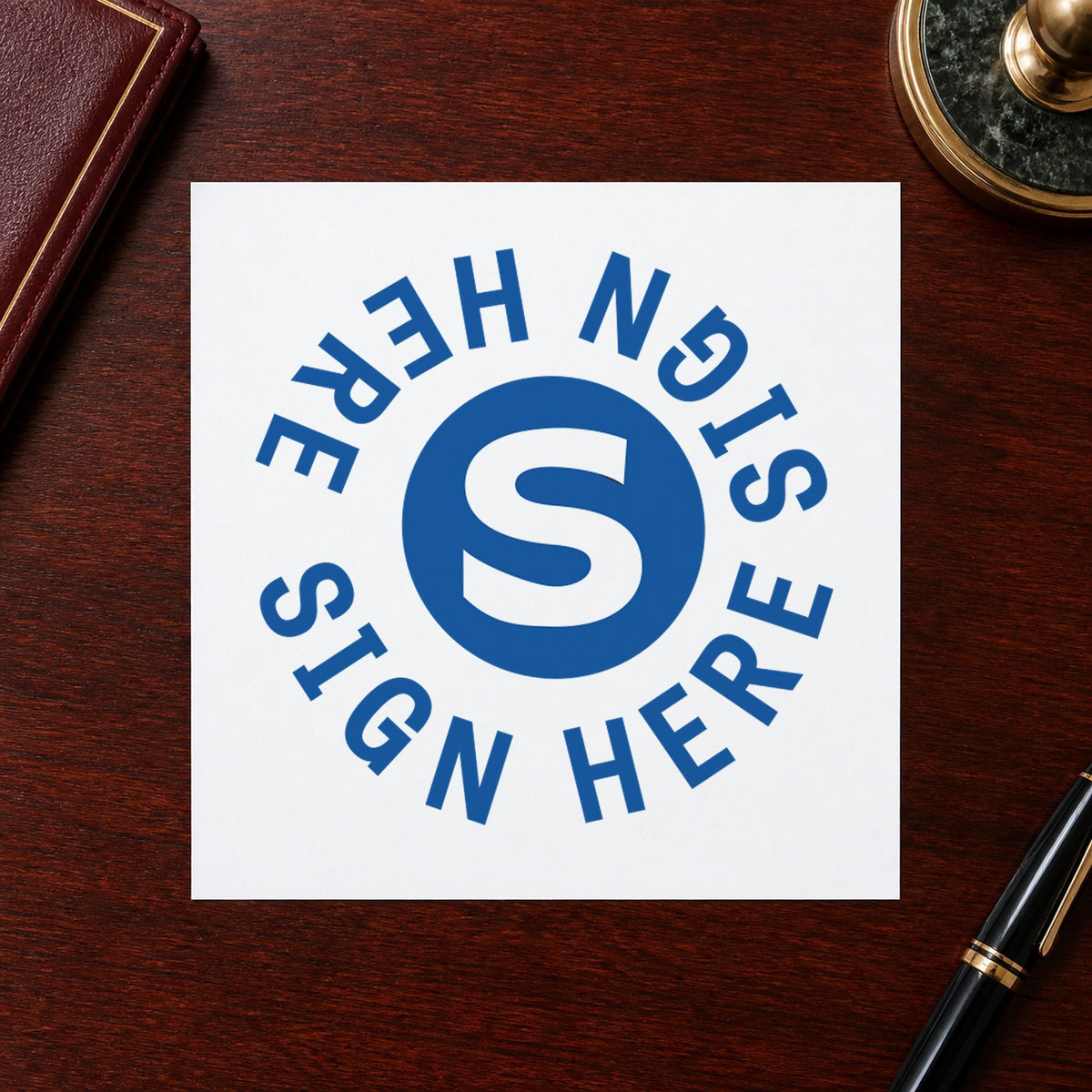 "Sign here" Xstamper No. 11424 stamp shown in everyday handling