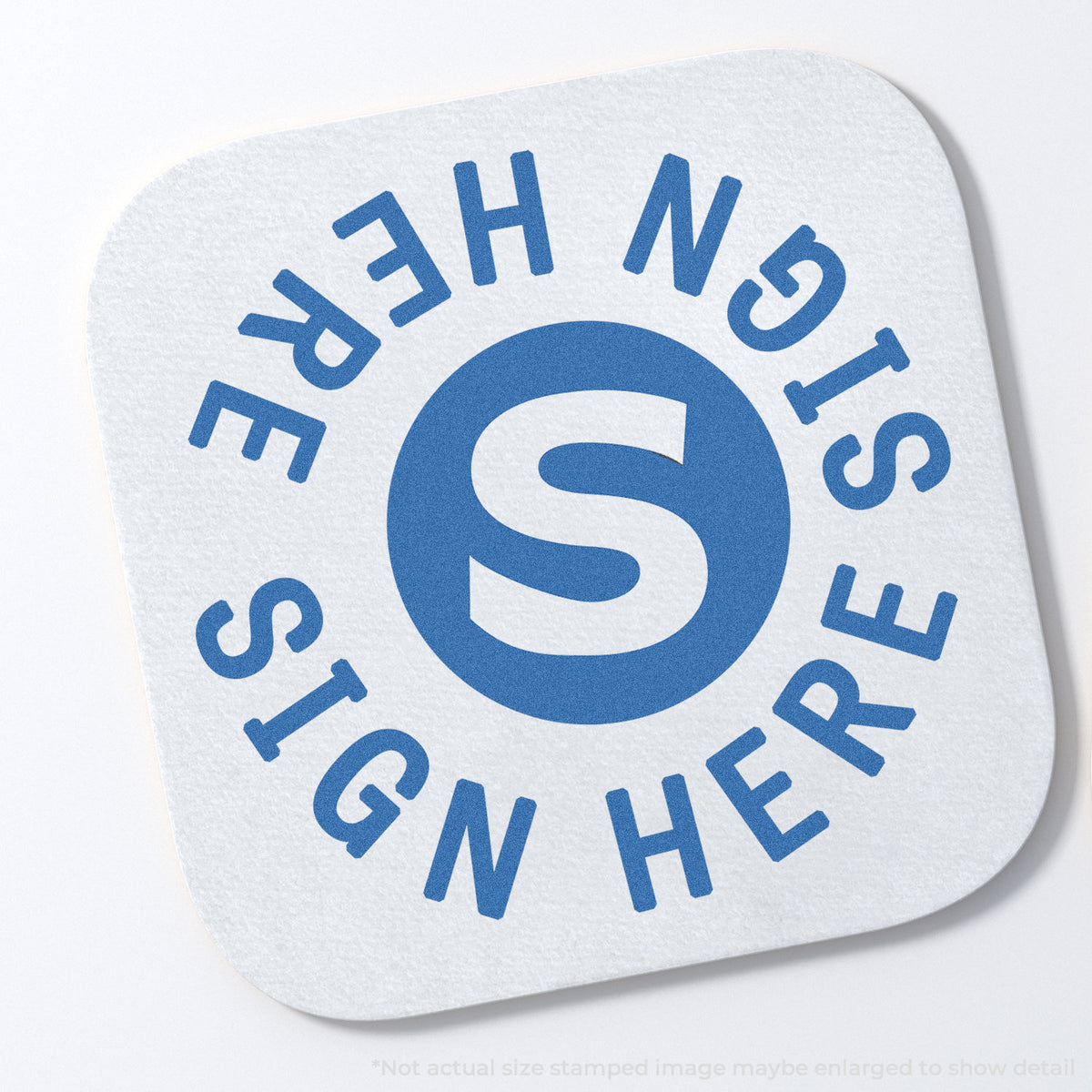 "Sign here" stamp and its crisp Approximately 5/8 in diameter impression on paper