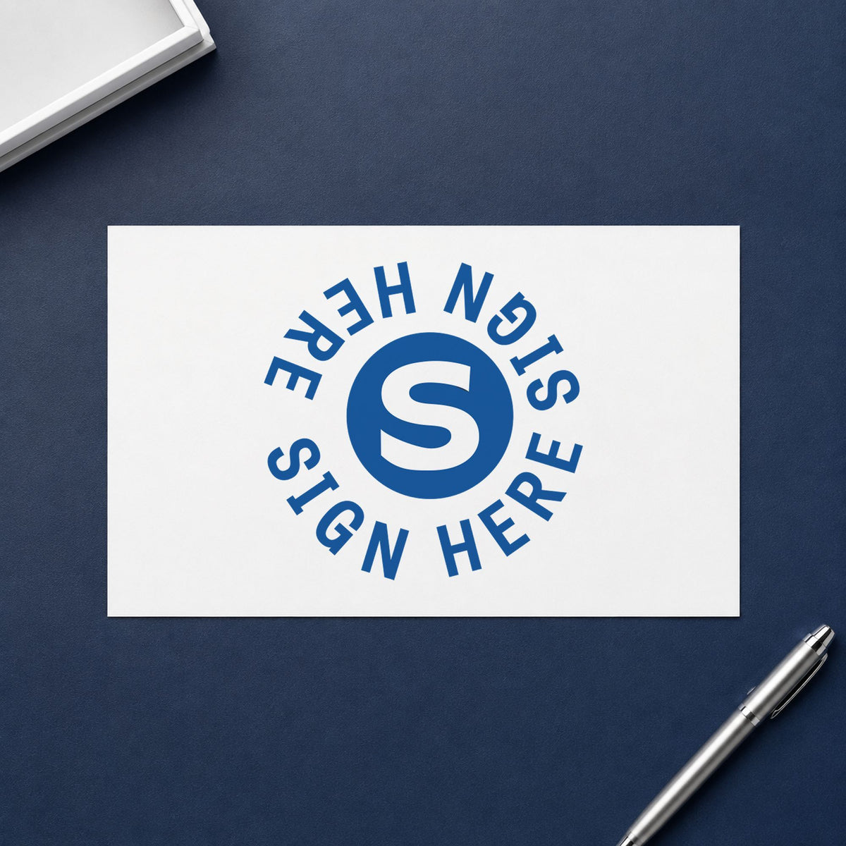 Pre-inked "Sign here" stamp applied to a document, Approximately 5/8 in diameter impression
