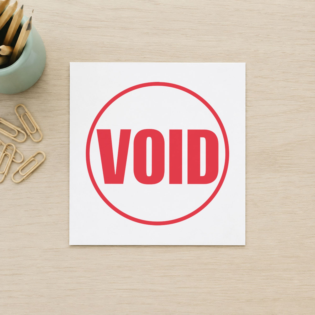 Pre-inked "Void" stamp marking paperwork in an office setting