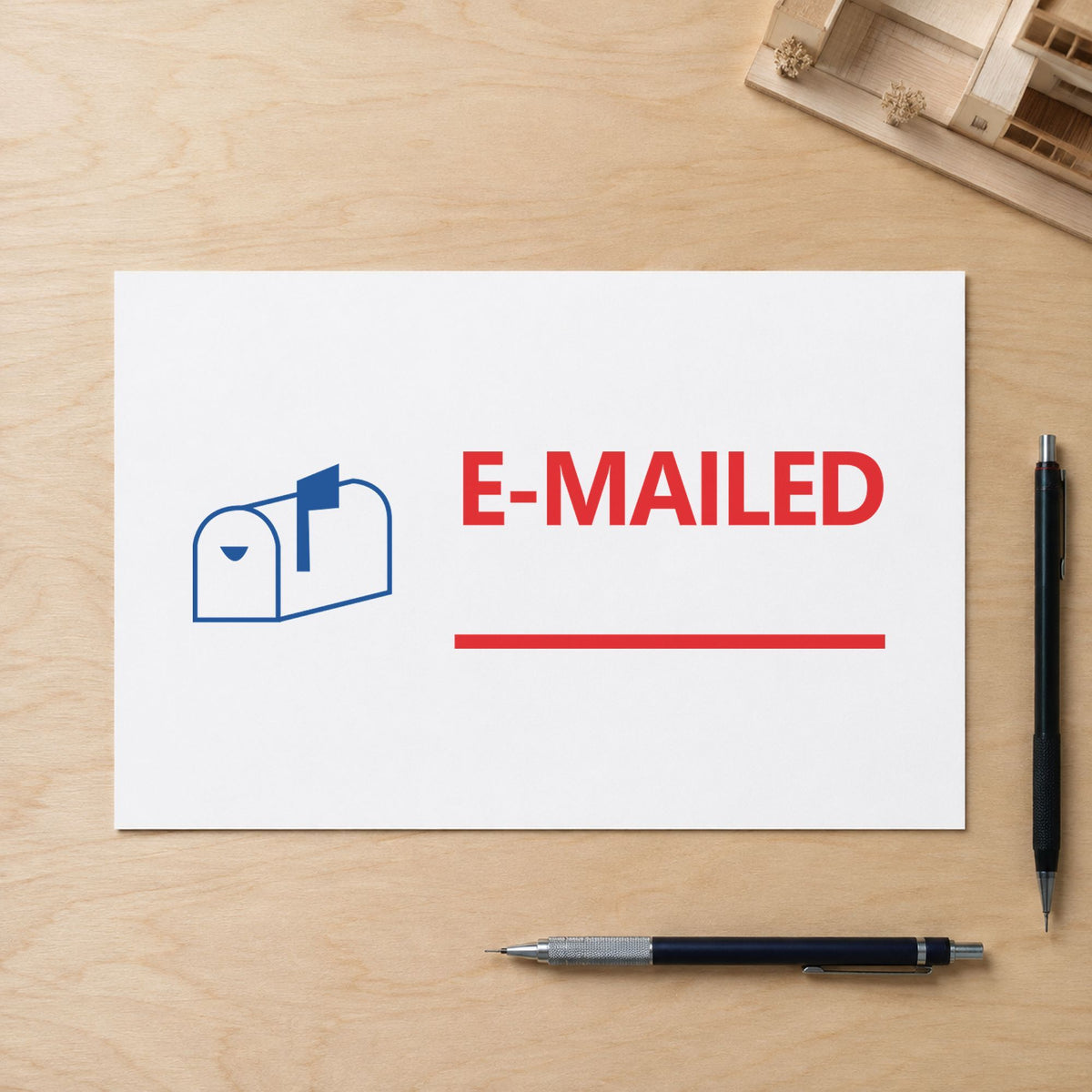 Pre-inked "Emailed" stamp applied to a document, Approximately 1/2 in tall x 1-5/8 in wide impression