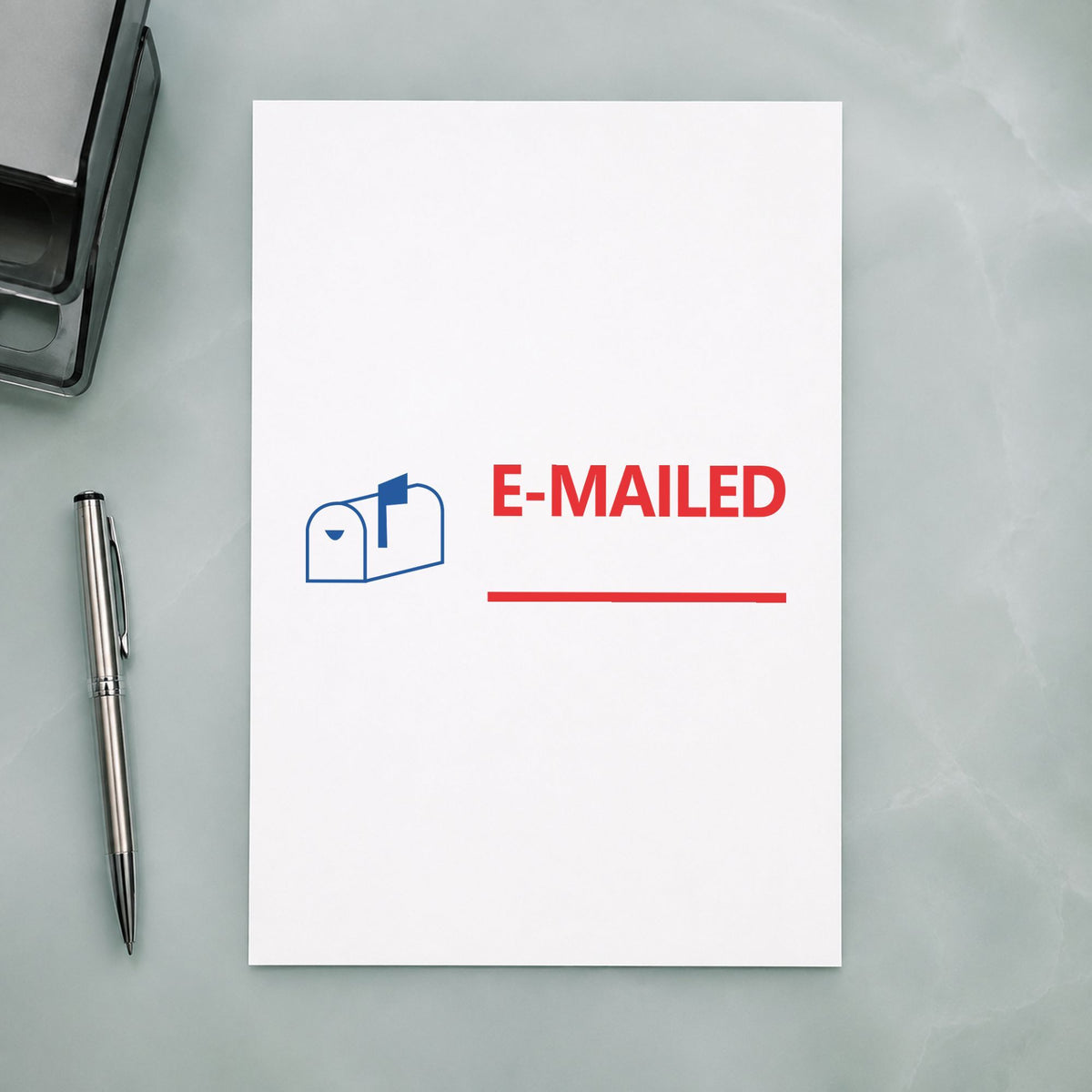 Pre-inked "Emailed" stamp marking paperwork in an office setting