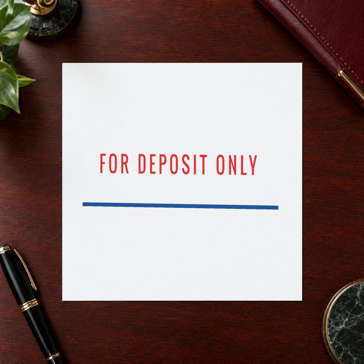 "For deposit only" Xstamper stamp in use on paper, 1/2 x 1-5/8 in rectangle imprint