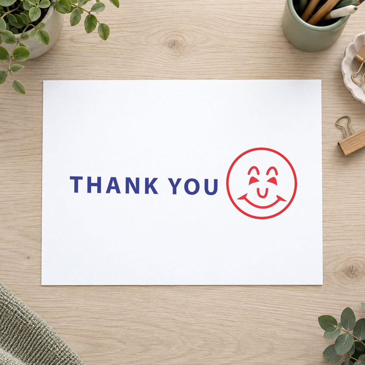 "Thank you" Xstamper stamp in use on paper, 1/2 x 1-5/8 in rectangle imprint