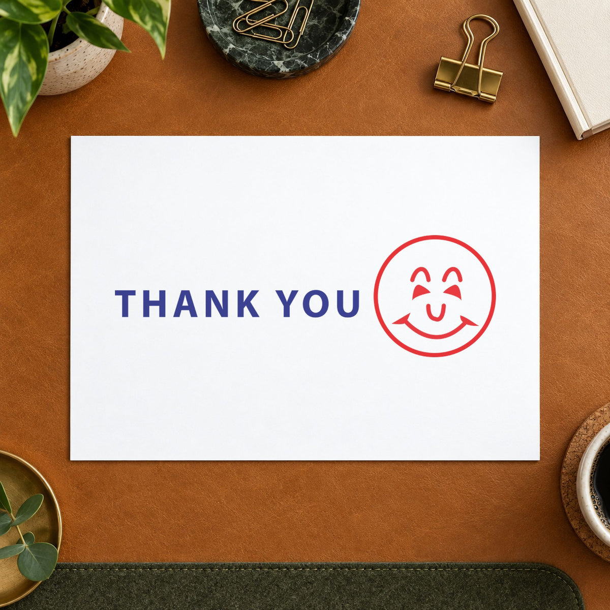 "Thank you" Xstamper pre-inked stamp beside its rectangle imprint