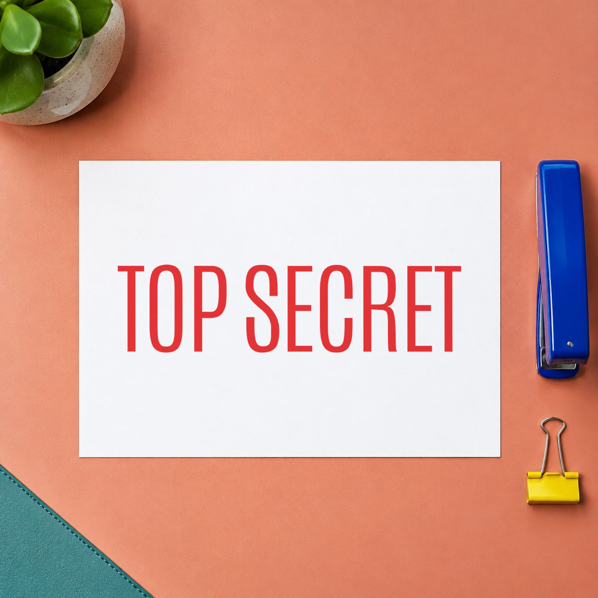 Pre-inked "Top secret" stamp applied to a document, Approximately 1/2 in tall x 1-5/8 in wide impression