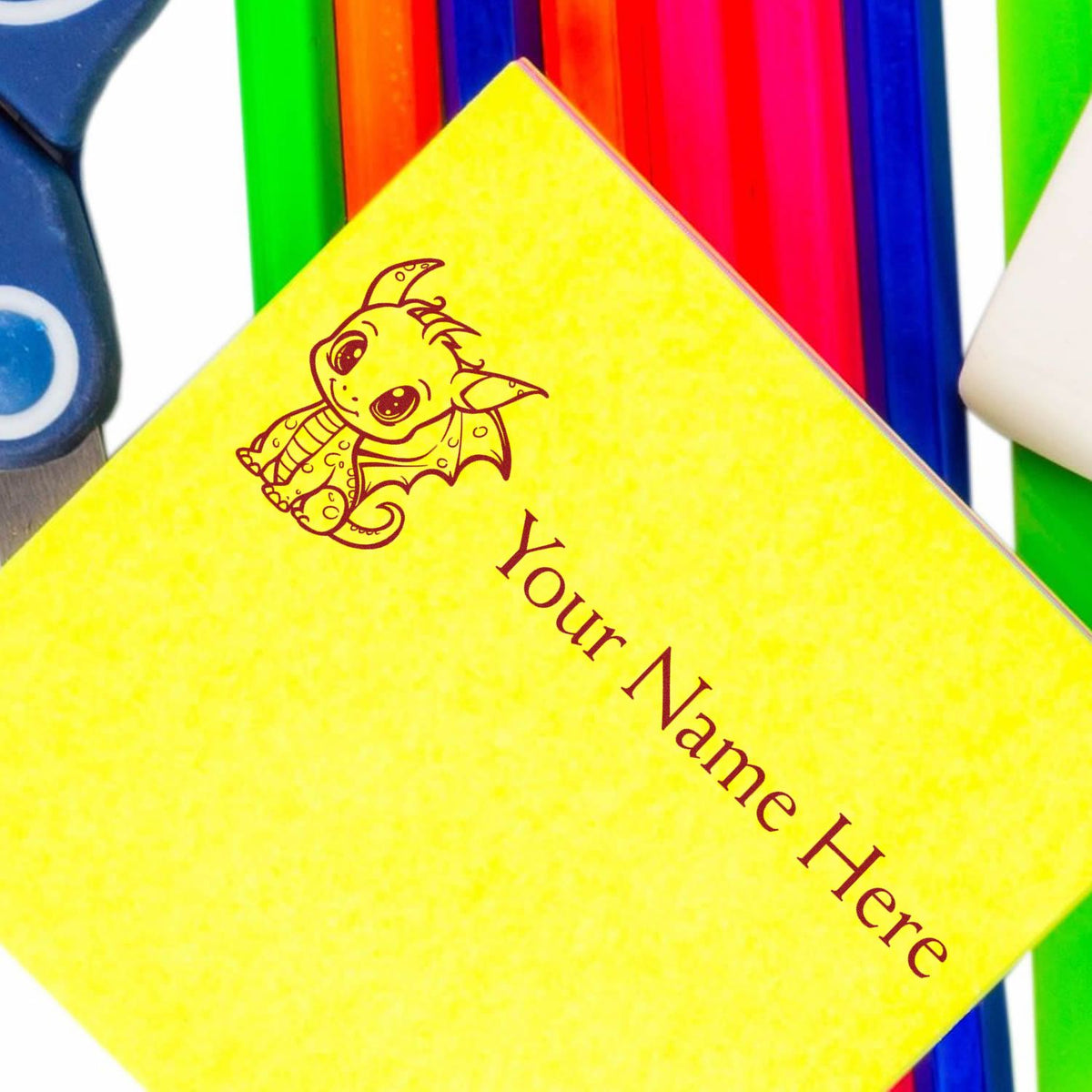 Yellow custom stamp and seal with dragon design and Your Name Here, set against colorful stamp handles.