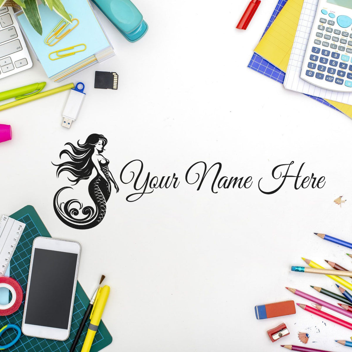 Custom black mermaid stamp and seal with Your Name Here on white, framed by colorful office supplies.