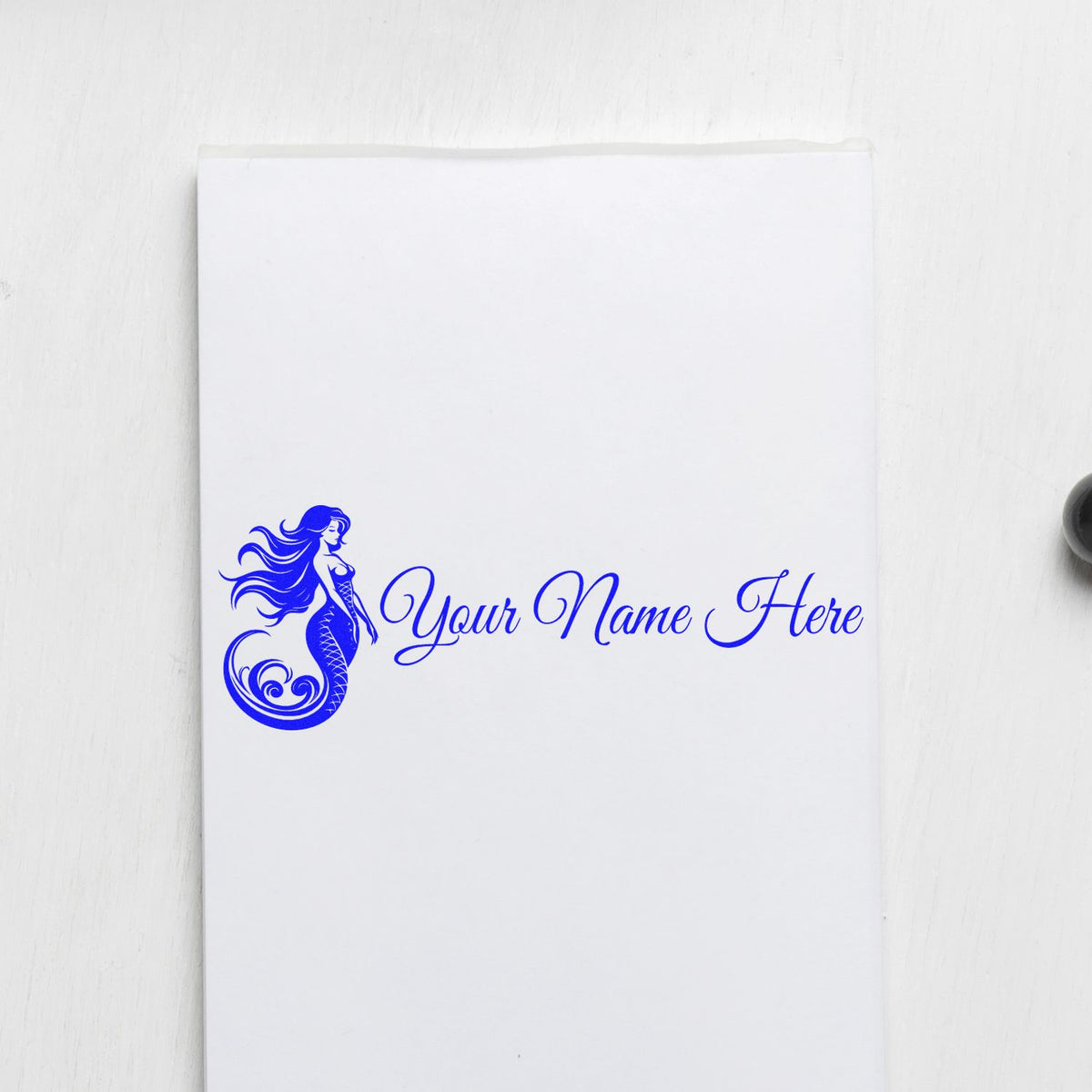 Blue mermaid custom stamp seal with cursive Your Name Here on white paper