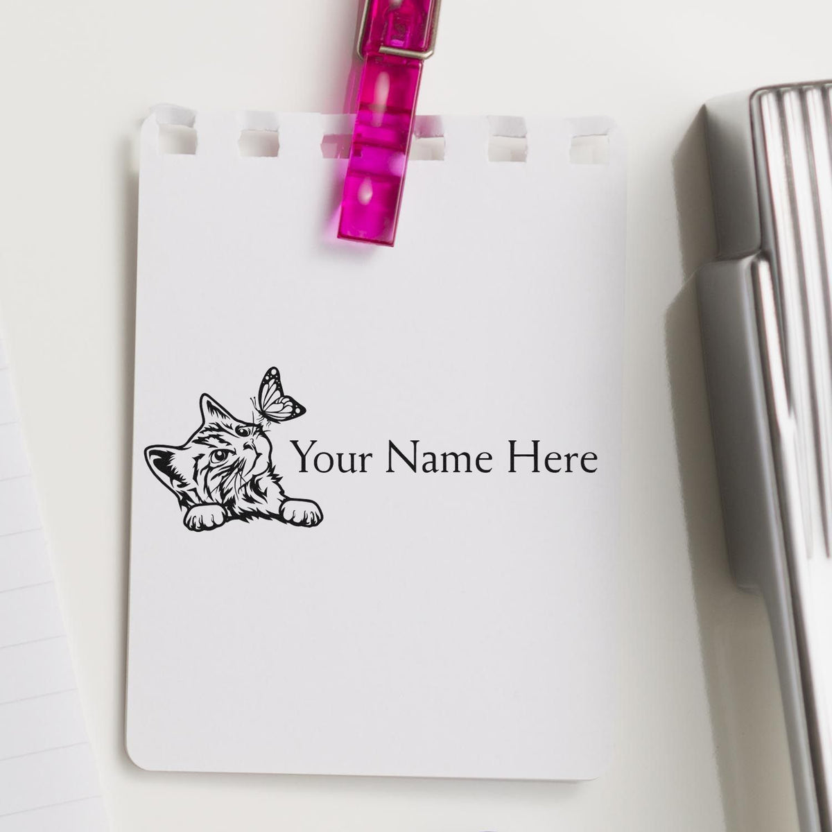 Personalized stamp and seal set with black cat and butterfly design on white card, clipped with bright pink clip and silver seal.
