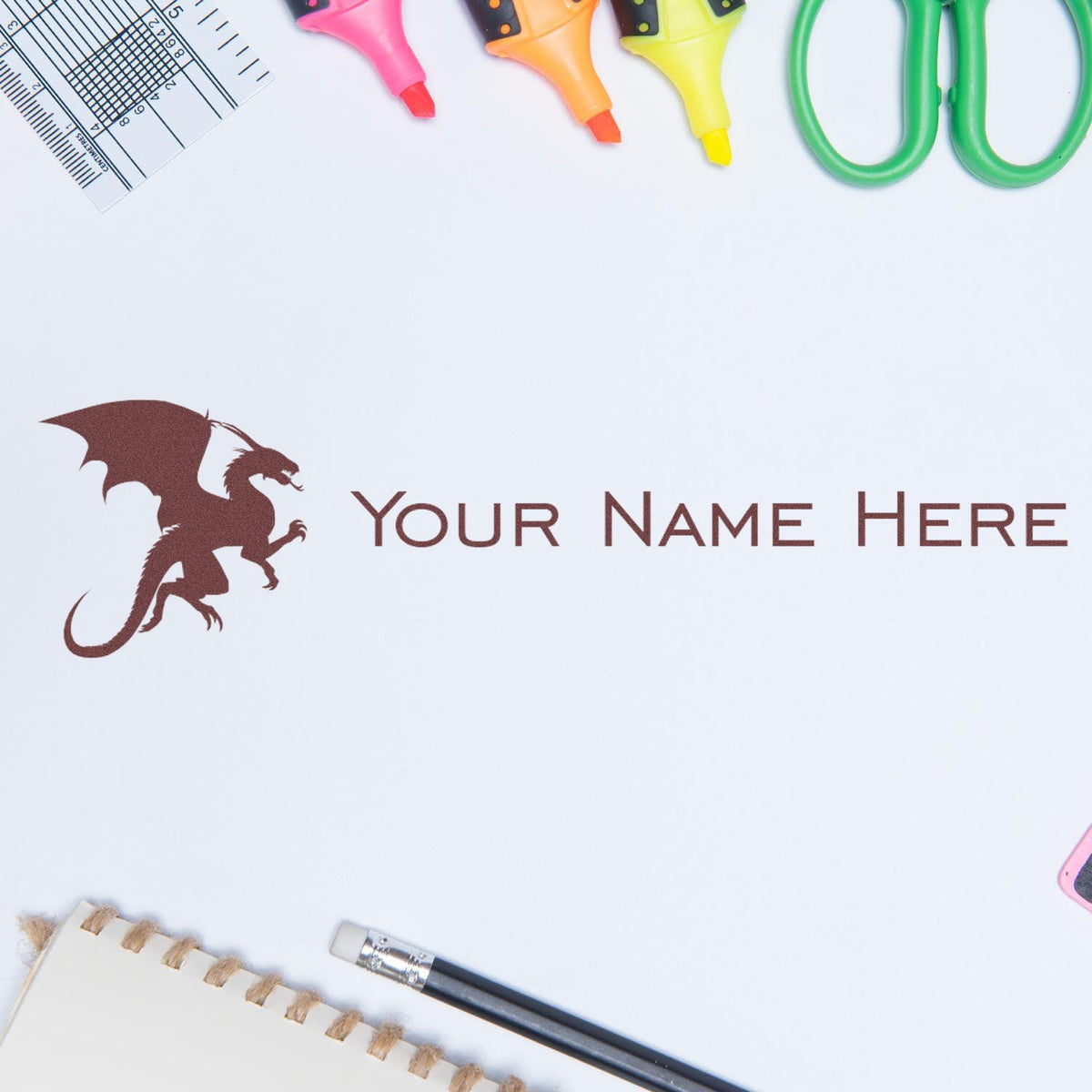 Custom brown dragon name stamp and seal on white paper, with colorful highlighters, ruler and scissors around the edges.