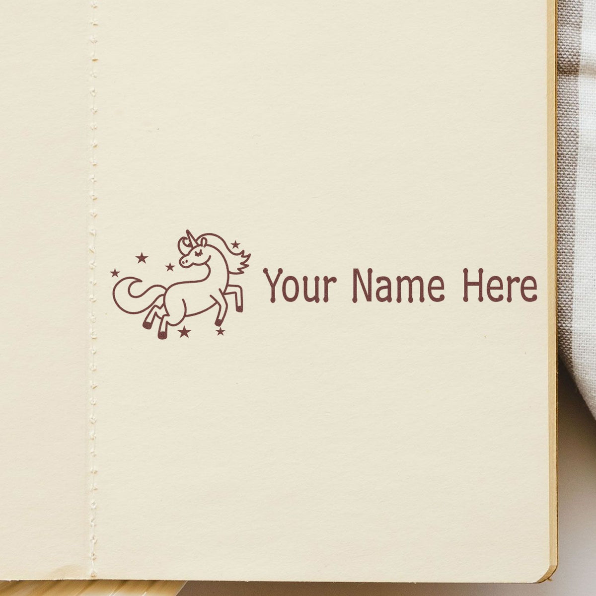 Cream paper with maroon unicorn custom stamp seal, stars, and Your Name Here text.