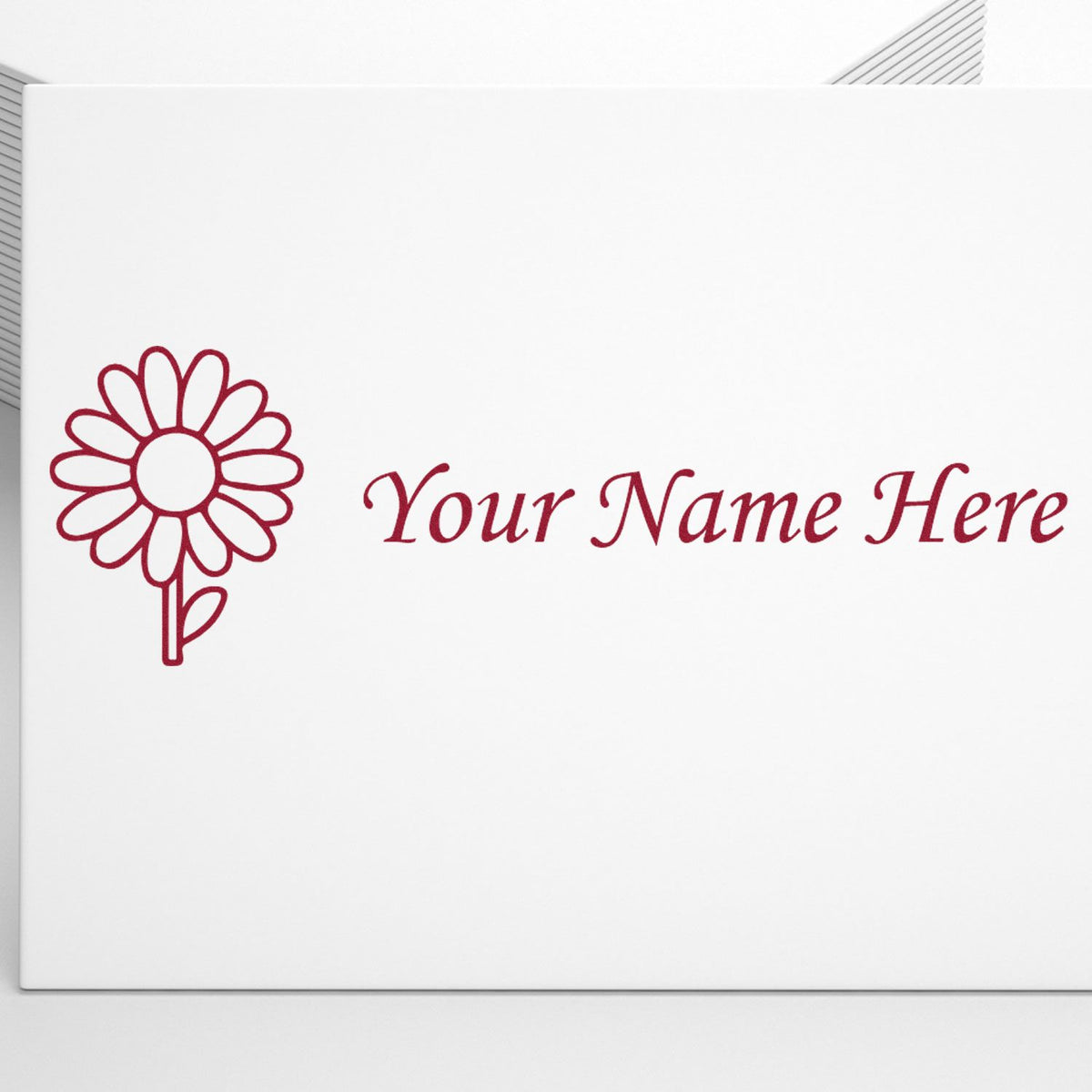 Burgundy custom stamp and seal design with flower logo and Your Name Here on a white background.