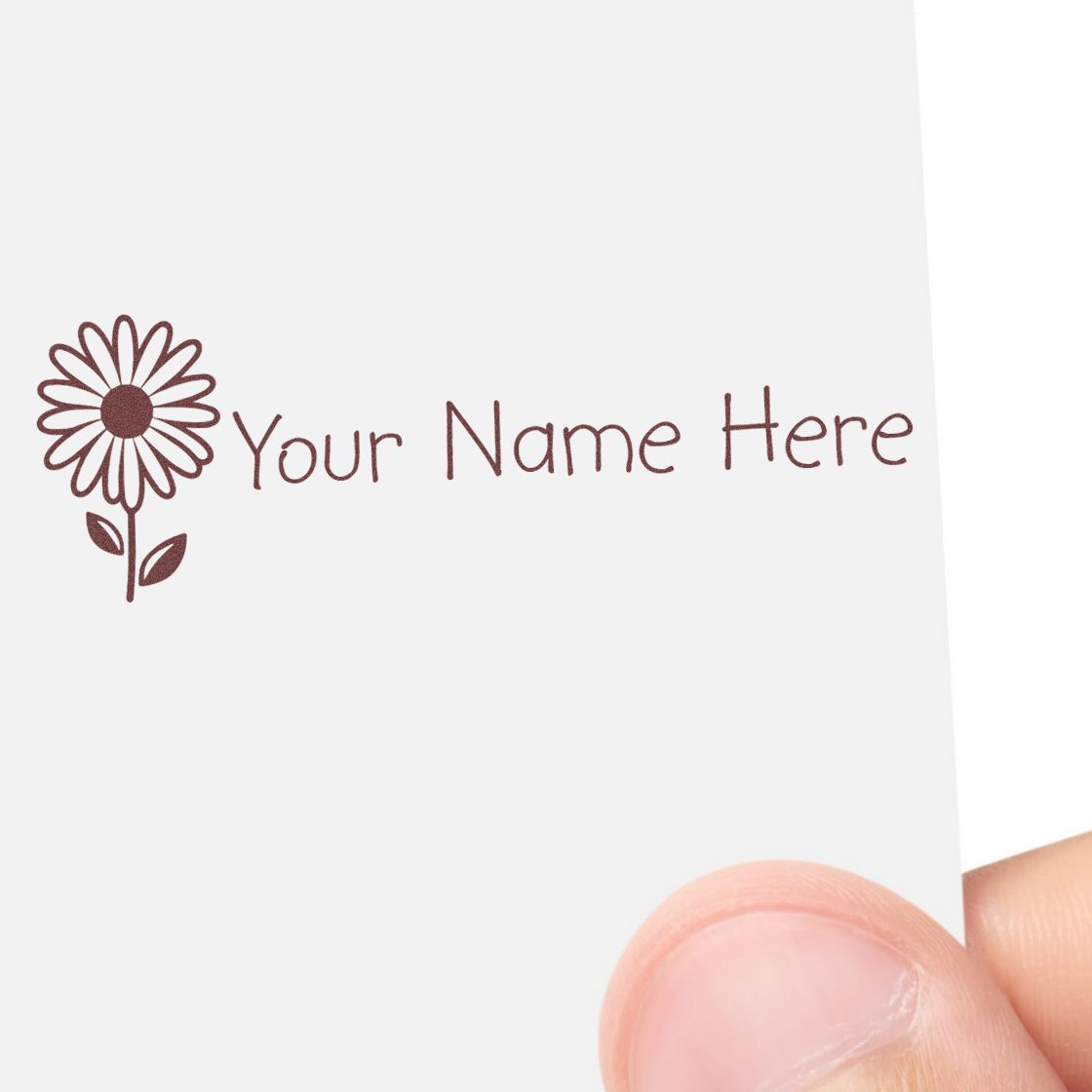 Brown floral stamp and seal design with Your Name Here on white card, held by a hand.