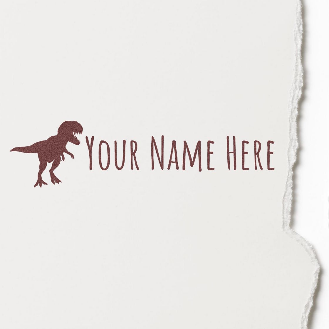 Custom maroon dinosaur stamp and seal with YOUR NAME HERE on white torn-edge paper.