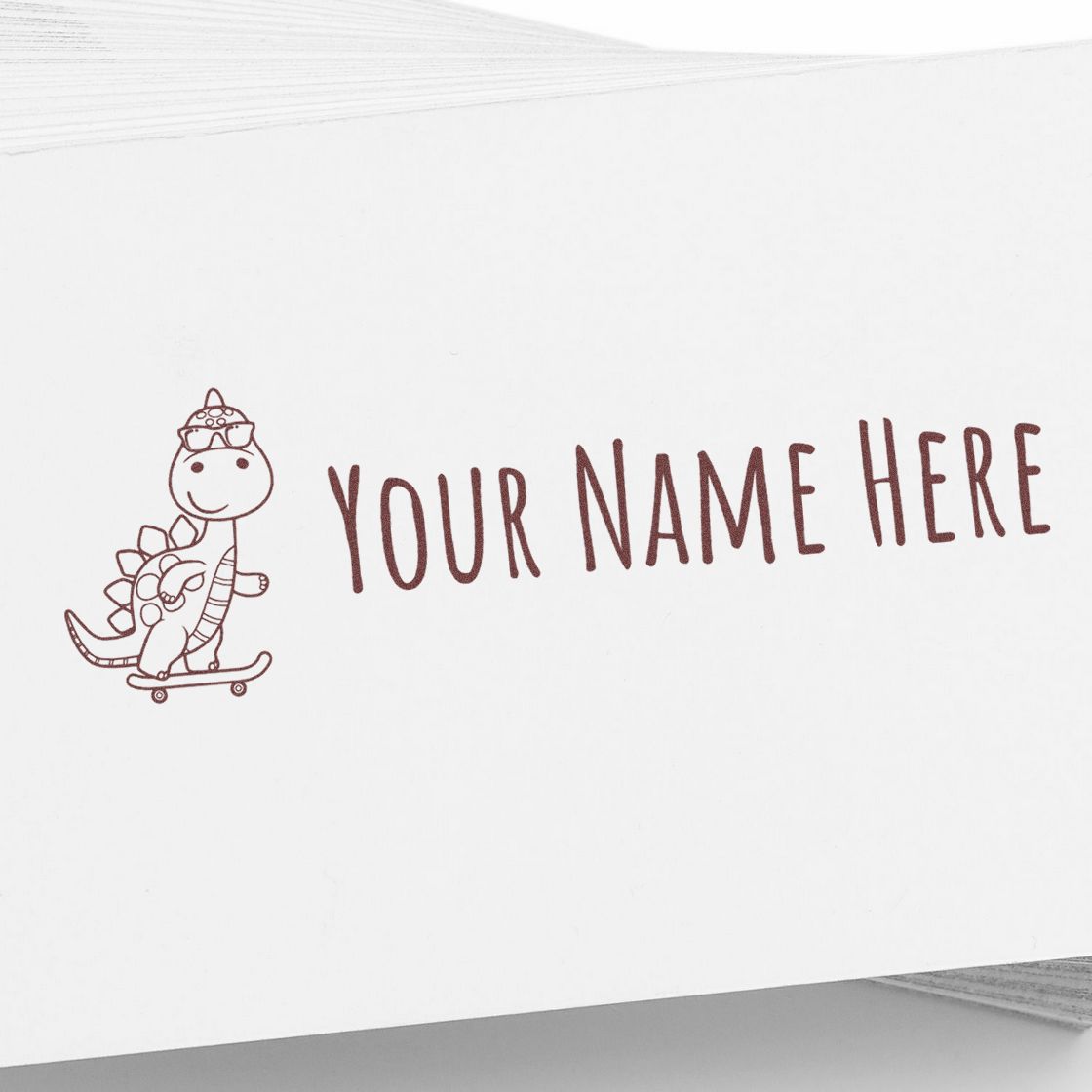 Brown custom stamp/seal design with cartoon dinosaur on skateboard and YOUR NAME HERE text on white paper.
