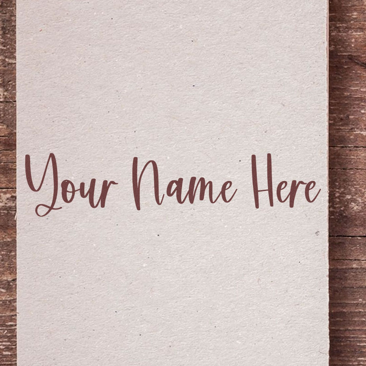 Cream custom stamp and seal card with brown script Your Name Here on rustic wood background.