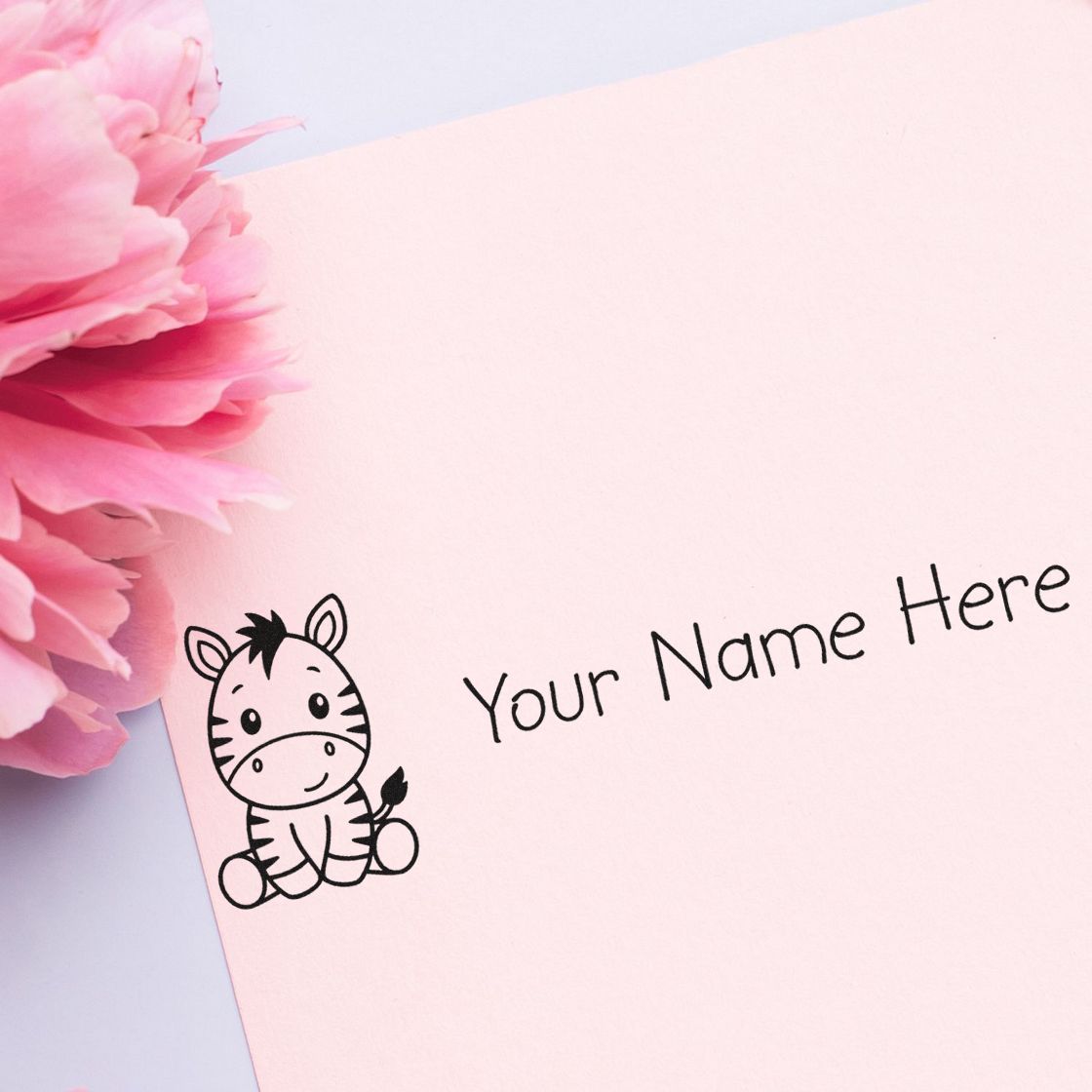 Custom zebra name stamp and seal on pastel pink paper with black Your Name Here text and pink flowers.