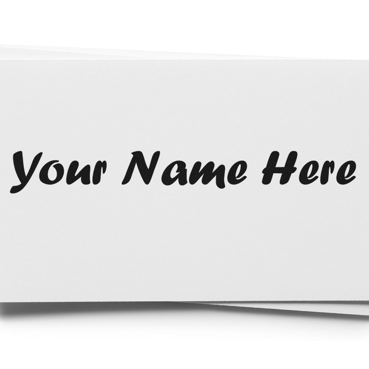 Black custom stamp and seal reading Your Name Here on white folded paper product.