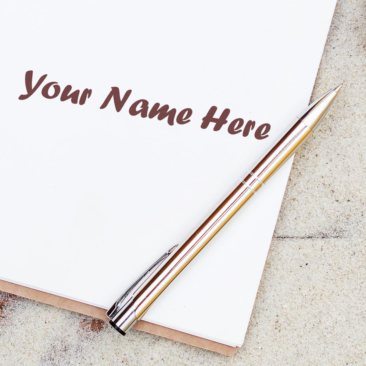 Personalized brown stamp and seal text on white paper with gold-and-silver pen on a beige surface.