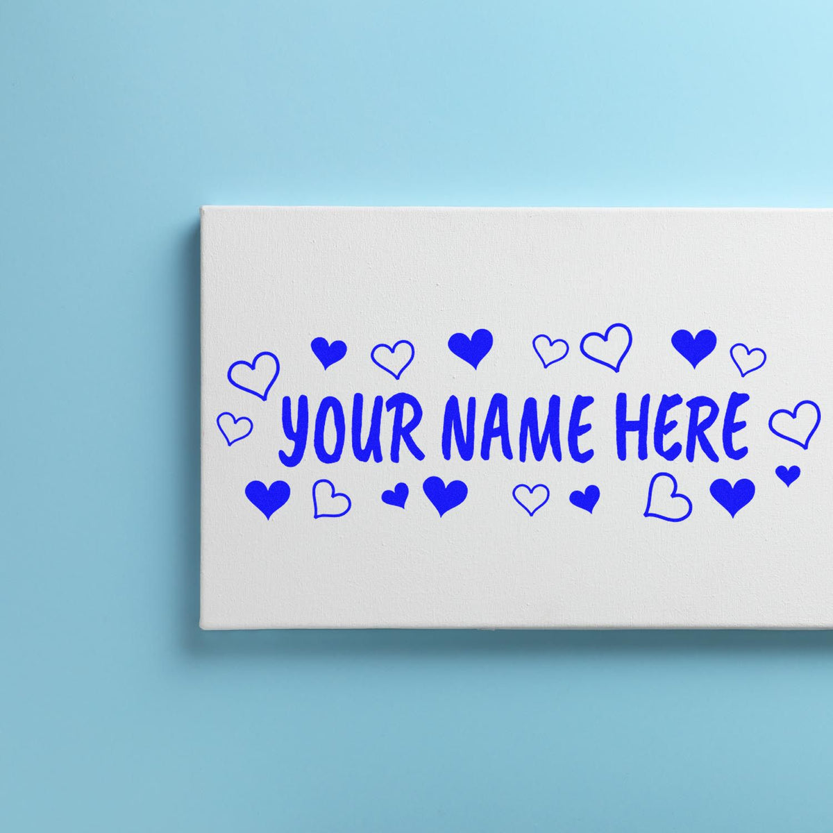 Custom blue heart stamp and seal on white box with YOUR NAME HERE on a light blue background.