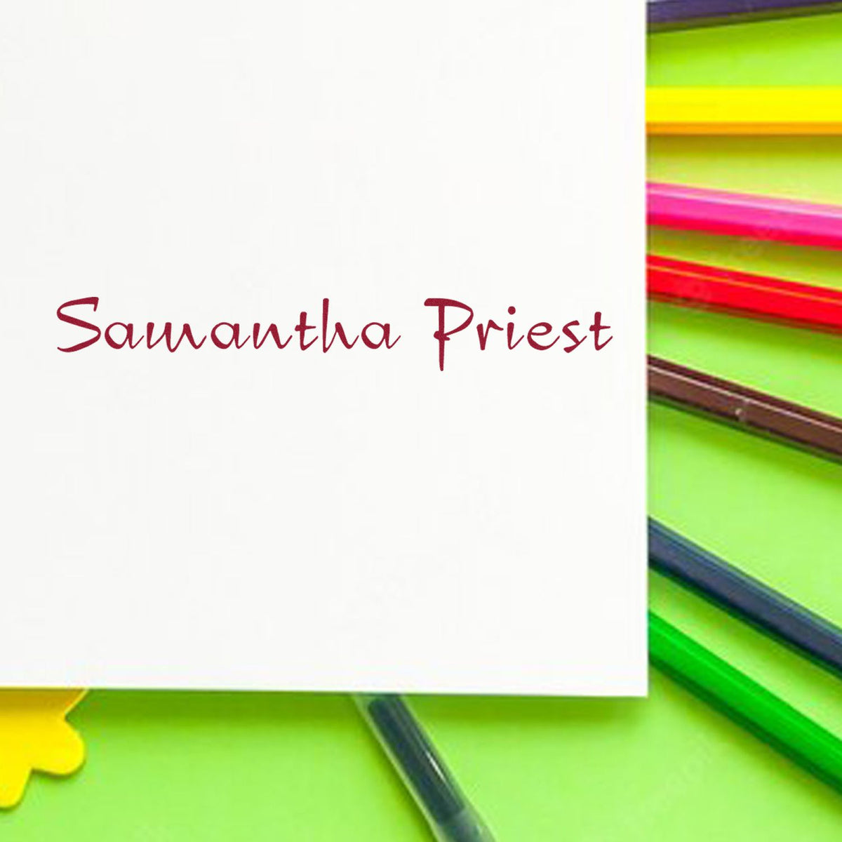 Custom burgundy stamp and seal reading Samantha Priest on white card, with neon green, yellow and pink accents.