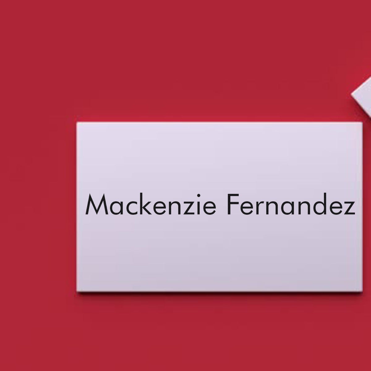 Custom white stamp and seal reading Mackenzie Fernandez on a red background