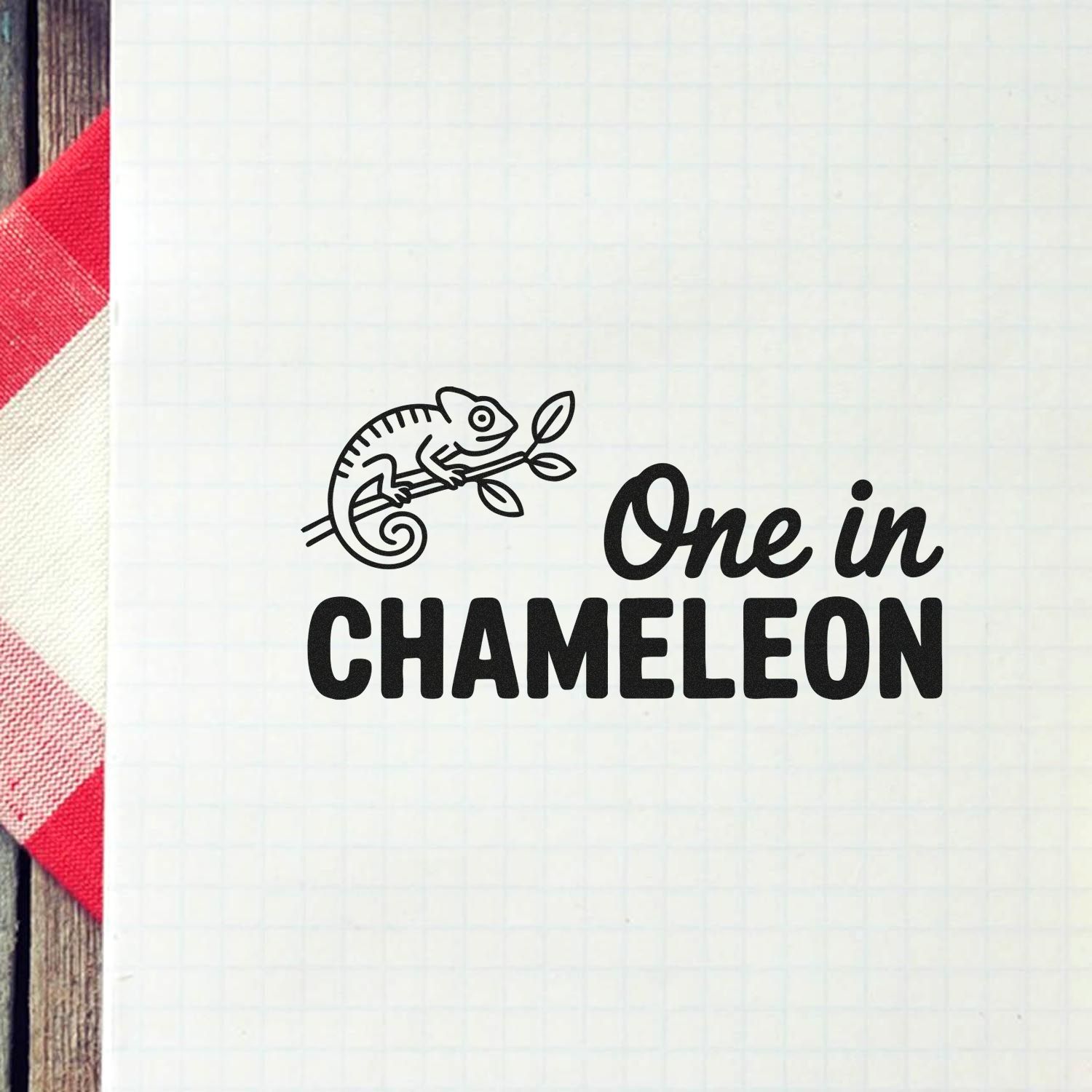 Black One in CHAMELEON stamp and seal design with chameleon line art on white grid paper.