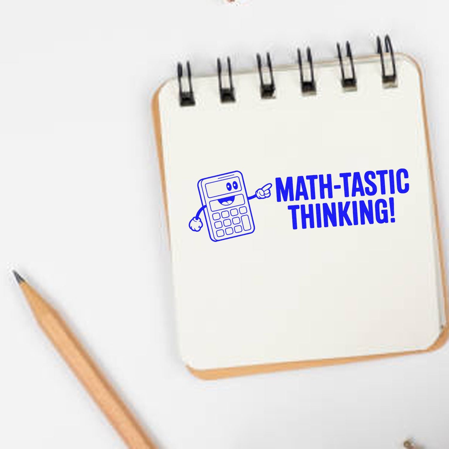 Blue math-tastic thinking stamp seal with calculator mascot on a white notepad, beside a pencil