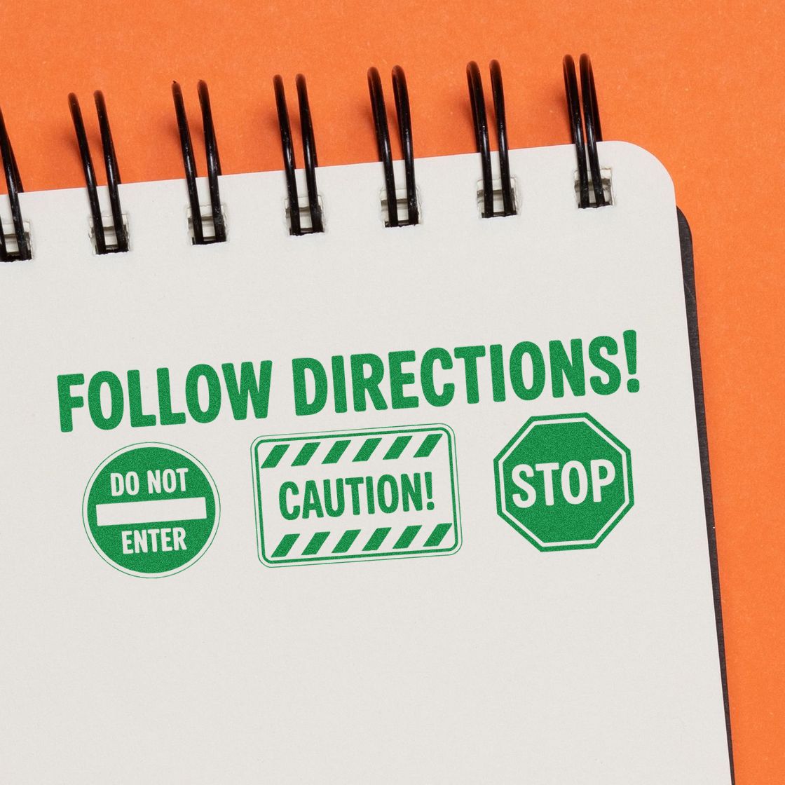 Green stamp-and-seal set with Follow Directions, Do Not Enter, Caution, and Stop on a white notepad over orange background.