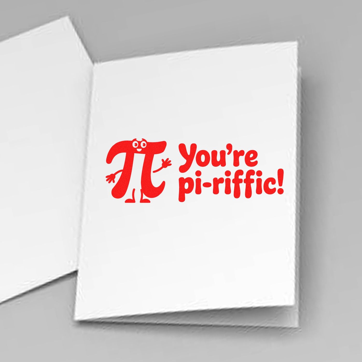 Red rubber stamp on white card reading Youre pi-riffic! with a cartoon pi character and playful math design.