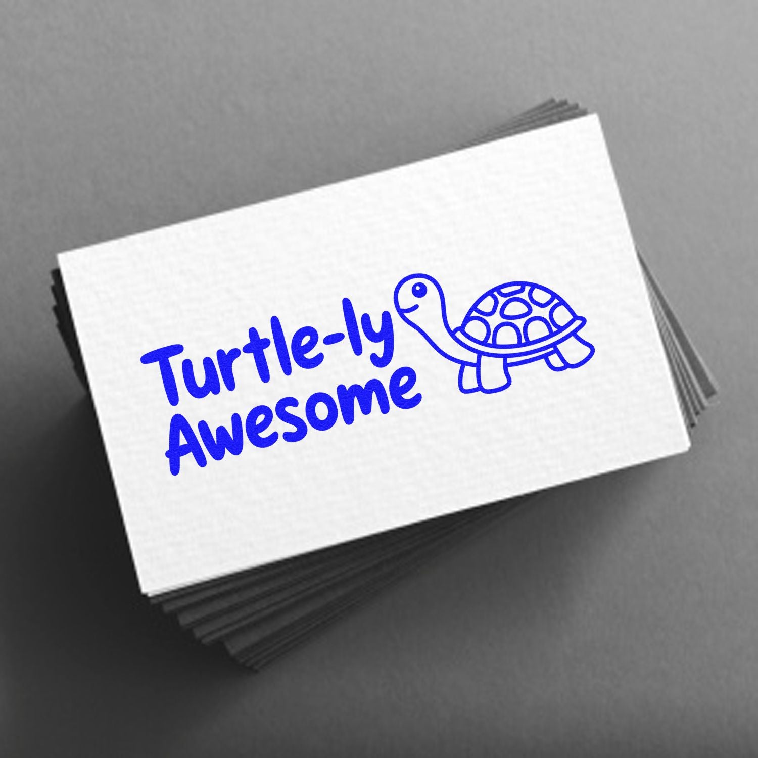 Blue Turtle-ly Awesome stamp and turtle seal on stacked white cards against a gray background