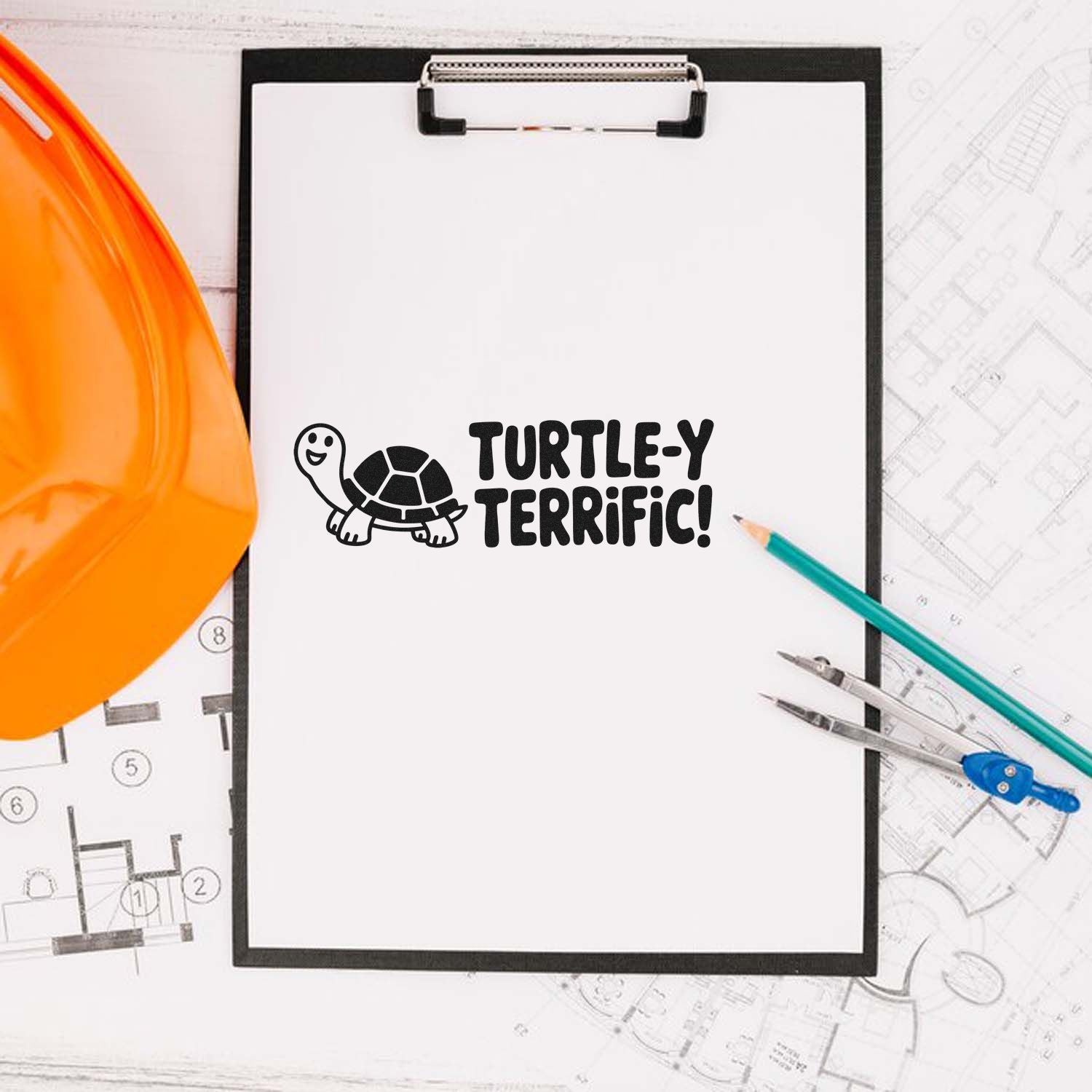 Black Turtle-y Terrific turtle stamp/seal on white clipboard, with orange hard hat and blue pencil.