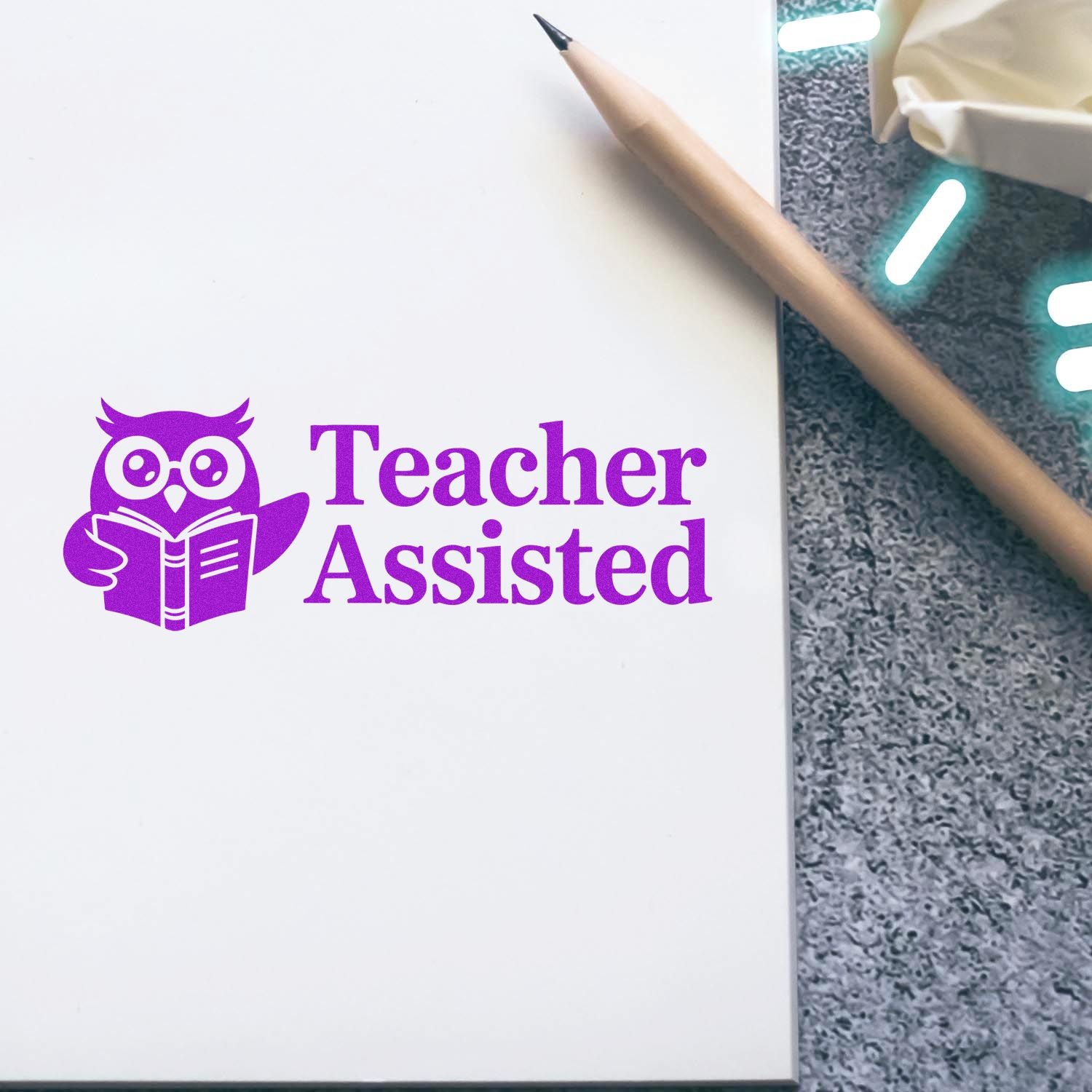 Purple Teacher Assisted stamp with owl reading a book on white paper beside a pencil.