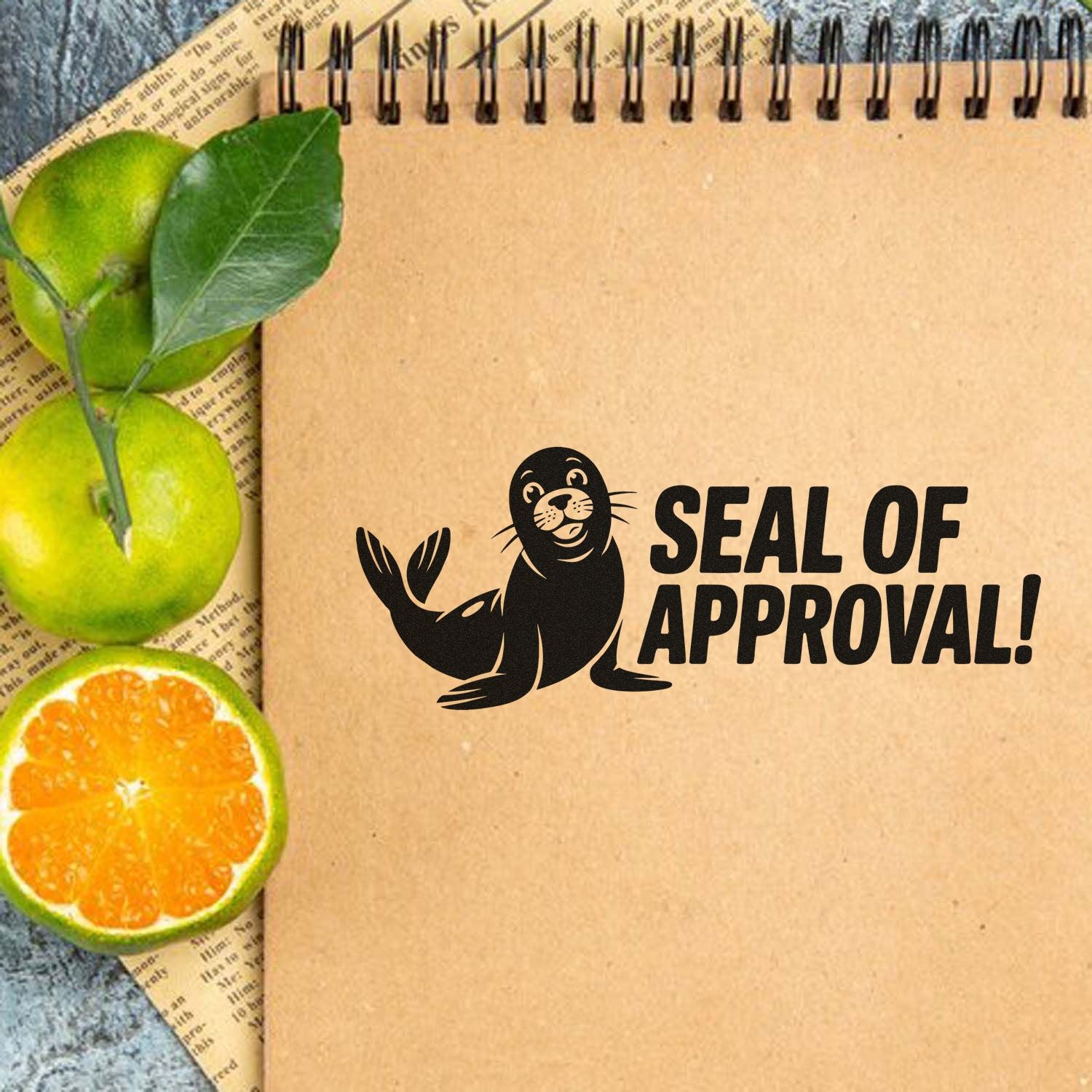 Black seal stamp reading SEAL OF APPROVAL! on a kraft notebook, with green leaves and sliced citrus accents.