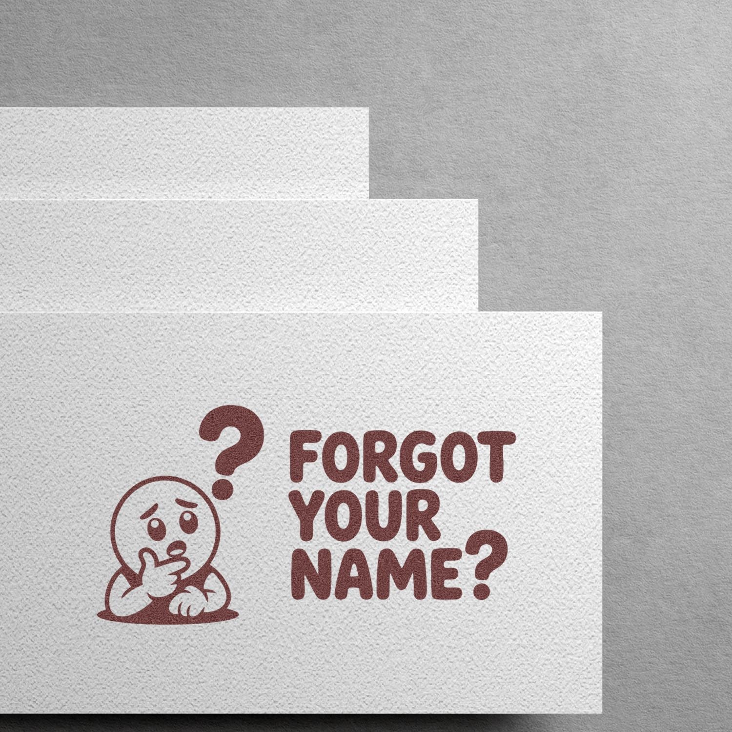 Maroon custom stamp seal reading FORGOT YOUR NAME? with confused character on textured white paper