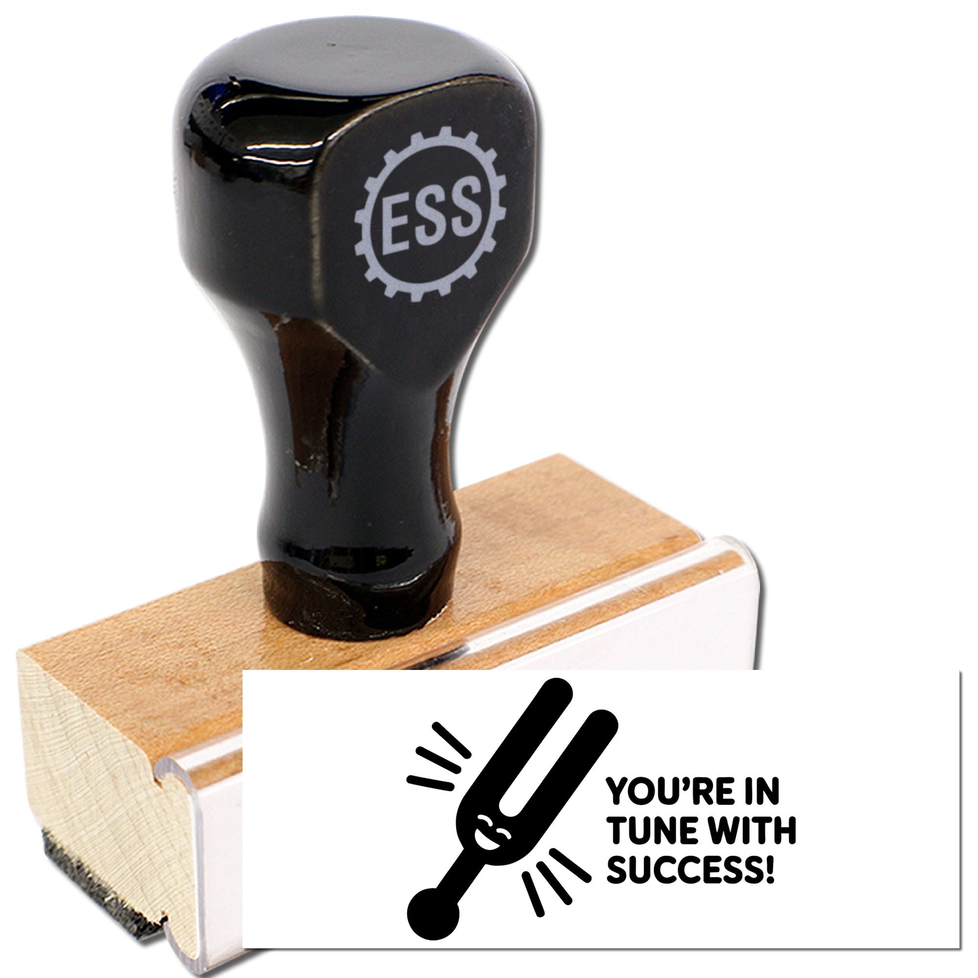 Black ESS rubber stamp and seal on a wooden block, with a white card showing a tuning fork and Youre in tune with success!