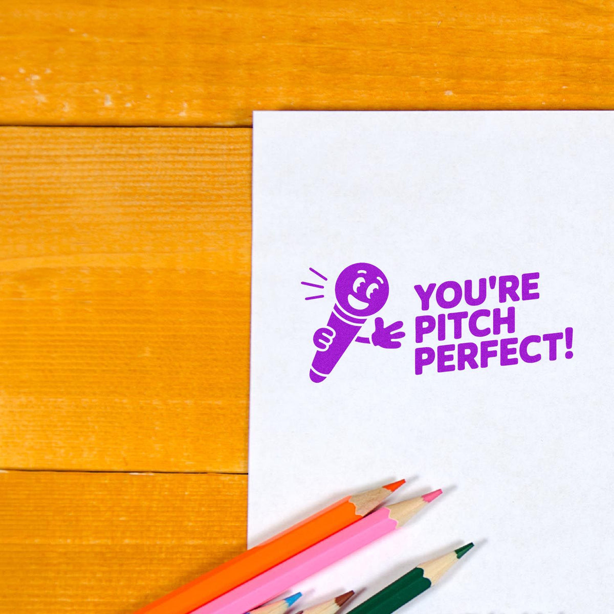 Trodat You're In Tune With Success teacher grading self-inking stamp in use, featuring a clear, professional stock stamp design.