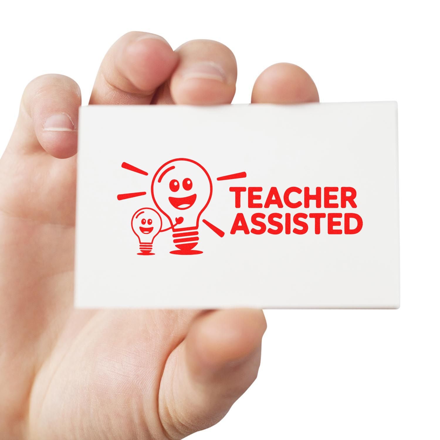 Handheld white rubber stamp with red Teacher Assisted text and smiling lightbulb seal logo.