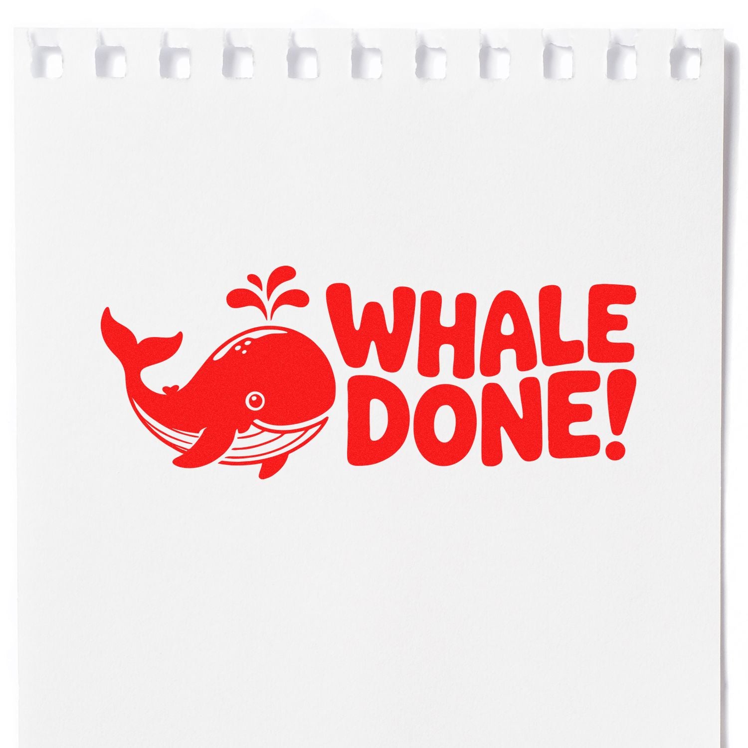 Red whale WHALE DONE! rubber stamp seal on white paper, with playful lettering and notebook-style top edge