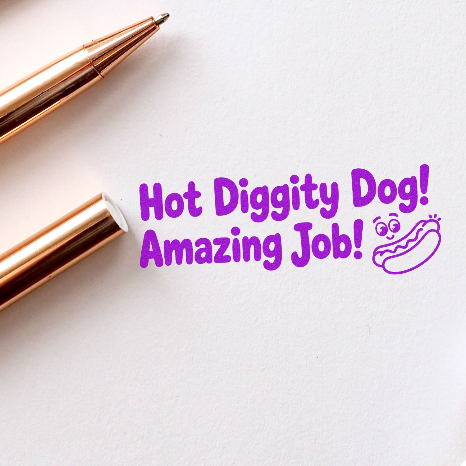Rose gold stamp and seal tools on white paper with purple Hot Diggity Dog! Amazing Job! text and hot dog doodle.