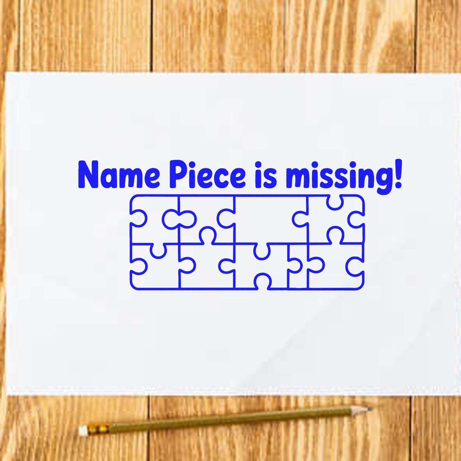 Blue stamp and seal design reading Name Piece is missing! with a blue puzzle outline on white paper over a wooden background.