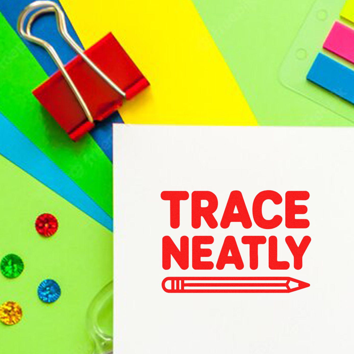 Red TRACE NEATLY stamp seal on white paper with pencil icon, surrounded by colorful paper and a binder clip.