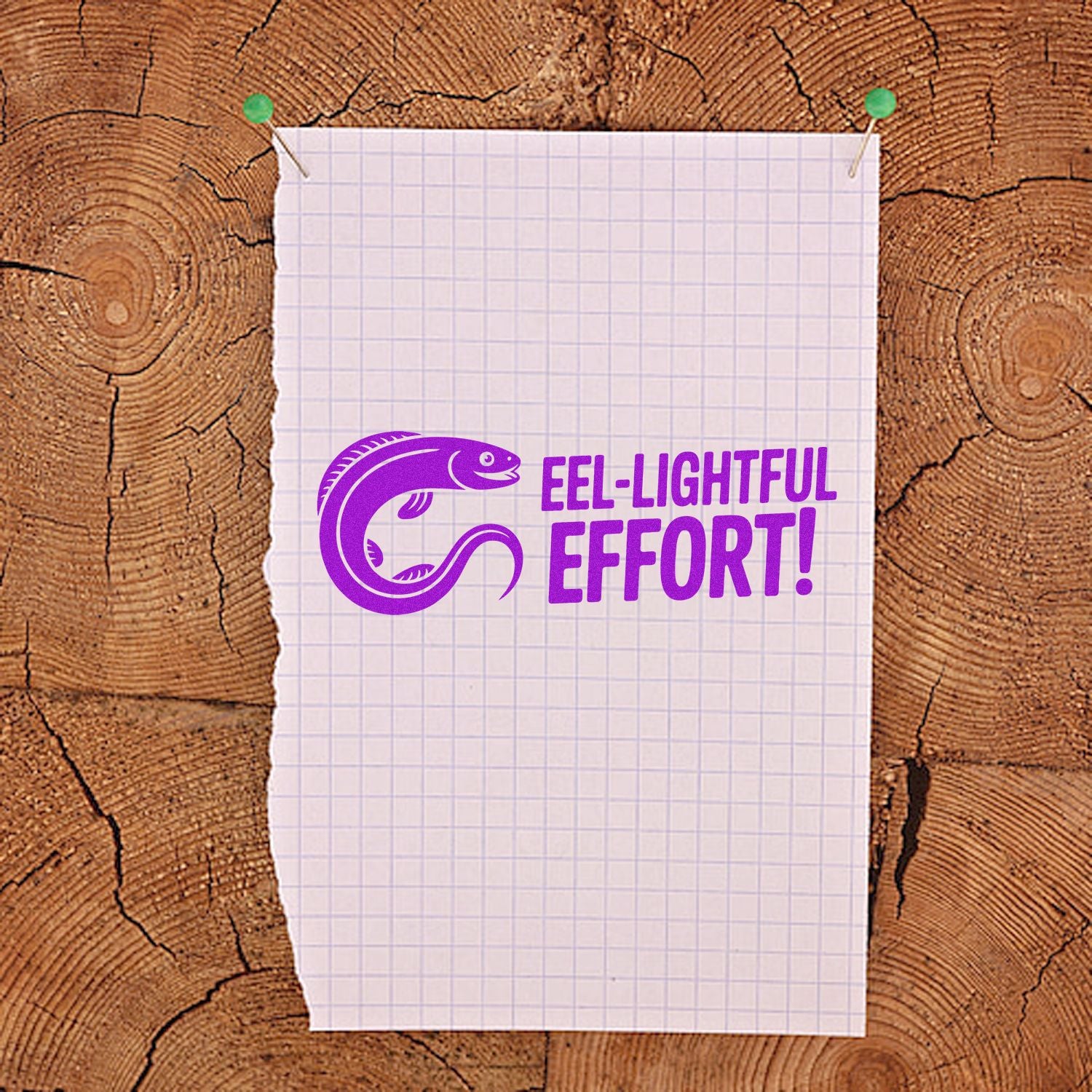 Purple eel-shaped stamp and seal with EEL-LIGHTFUL EFFORT! on pinned graph paper over wood grain background